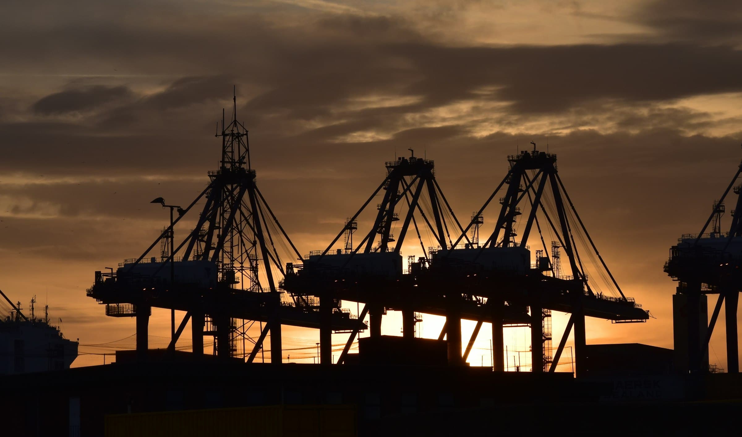 Container port silhouetted at sunset
